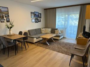 a living room with a couch and a table at Koralpen Appartement in Rieding