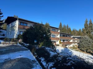 an apartment building with snow on the ground at Koralpen Appartement in Rieding