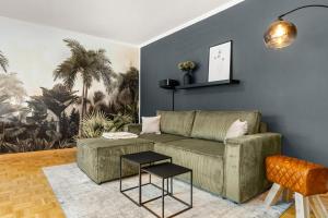 a living room with a couch and two tables at Heritage - Perfekt für Gruppen, 15min Willingen in Brilon