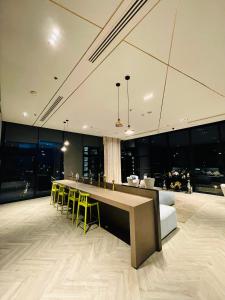 a living room with a bar and yellow chairs at The base Condo 2 bedroom 1 bathroom in Pattaya +122 photos