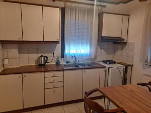 A kitchen or kitchenette at Anilio Rooms