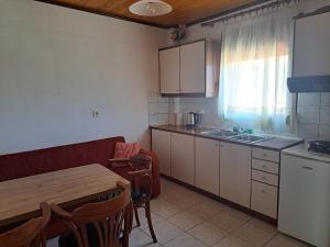 A kitchen or kitchenette at Anilio Rooms