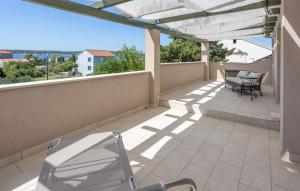 a balcony with a chair and a table and chairs at Rab Barbat Villas 4 stars 300 sea in Barbat na Rabu
