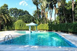 a swimming pool with a gazebo in a yard at Kazi Resort & Hotel in Rājābāri