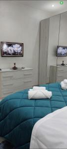 a bedroom with two beds with a blue blanket at b&b al lago Mady in Avigliana