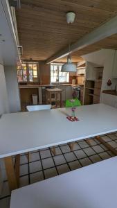 a kitchen with a white table in a room at Den lille Græsgård in Augustenborg +5 photos