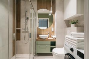 a bathroom with a sink and a shower at Native Apartments Kościuszki 39I29 in Kraków +31 photos