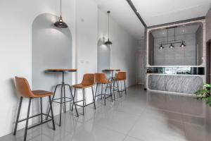a group of stools in a room with a window at Penghu SunSea Hall in Magong