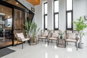 a group of chairs in a lobby with plants at Penghu SunSea Hall in Magong +84 photos