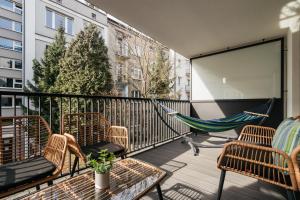 a balcony with chairs and hammocks on a building at Native Apartments Kościuszki 39I29 in Kraków