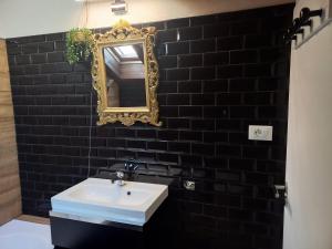 a bathroom with a white sink and a mirror at vinga holiday's house in Imperia +12 photos