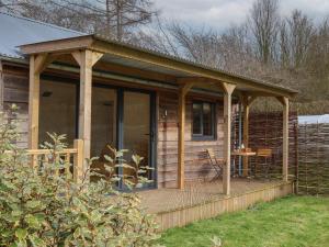 a wooden cabin with a porch and a deck at Beech Tree Cabin in York