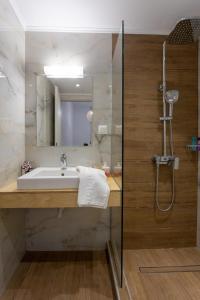 a bathroom with a sink and a shower at Avra 4 amazing house by the sea in Tsoútsouros