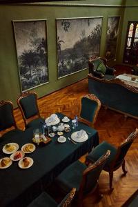 a dining room with a table with food on it at Golden Goose Villas in Bedugul
