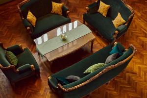 two chairs and a table in a living room at Golden Goose Villas in Bedugul
