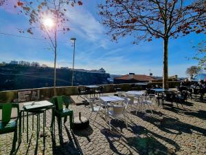 a group of tables and chairs on a patio at House with exclusive terrace in a private condo in Porto