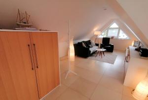 a living room with a large wooden cabinet and a living room at Fewo Grachtenhimmel- Appartement zum Entspannen in Krummhörn