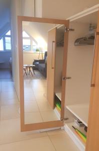 a mirror in a room with a living room at Fewo Grachtenhimmel- Appartement zum Entspannen in Krummhörn +50 photos