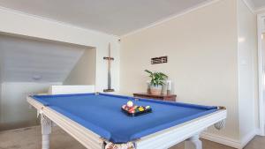 a pool table in a living room with ahibition at Salties Beach House KwaZulu-Natal in Sheffield Beach