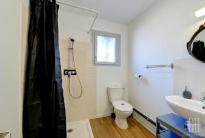 a bathroom with a shower and a toilet and a sink at Terre - Proche A 10 - 2V - Parking in Saint-Pierre-des-Corps +17 photos
