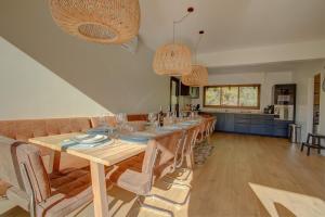 a dining room with a long table and chairs at Villa de la Source in Arcachon +47 photos