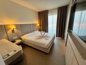 Ένα ή περισσότερα κρεβάτια σε δωμάτιο στο Hotel Porto Azzurro +76 φωτογραφίες