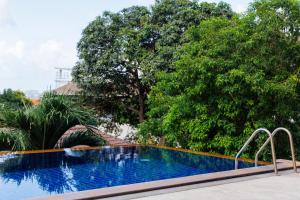 a swimming pool in front of some trees at Chaweng Hill with pool in Nathon Bay