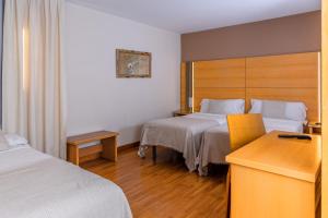 Voodi või voodid majutusasutuse Hotel Serrano toas