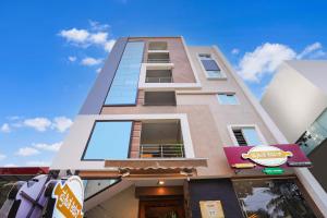 a tall building with a sign in front of it at Octave Hotel Stay Bliss in Bengaluru