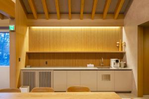 a kitchen with a counter and chairs in a room at Lulu Chalet Hakuba by Jade Villa in Hakuba
