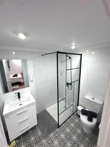a bathroom with a shower and a toilet and a sink at El Rincón de Pancho in Guía de Isora