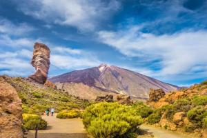 a mountain in the distance with people walking on a path at El Rincón de Pancho in Guía de Isora