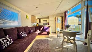 a living room with a couch and a table at Marton Mere - 3 Bedroom Caravan in Blackpool
