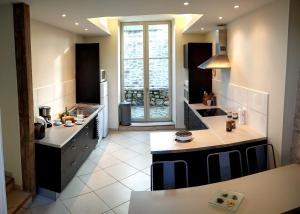 a large kitchen with a large window in it at Les Marronniers in Baron
