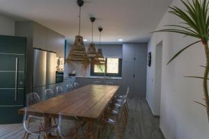 a dining room with a wooden table and chairs at Finca Florida in Benalup Casas Viejas