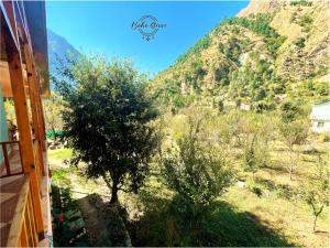 a view of a mountain from the window of a house at Boho Riverhouse in Gushaini