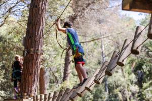 a person on a rope tied to a tree at EL COLLELL - Complejo Familiar in Sant Ferriol +92 photos