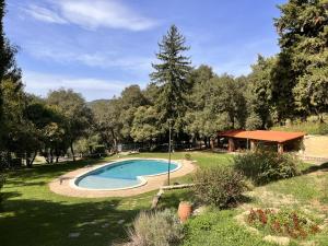 a swimming pool in the middle of a yard at EL COLLELL - Complejo Familiar in Sant Ferriol