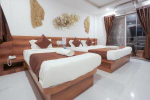 Hotel Green Exotica Mahabaleshwar客房内的一张或多张床位
