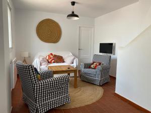 un salon avec deux chaises et un canapé dans l'établissement Azucena luxury town house in Conil with terrace and great views, à Conil de la Frontera