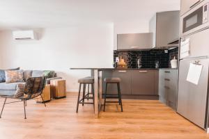 a kitchen with a table and chairs in a room at Apartamento Porta14 1 in Chaves +2 photos