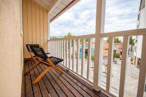 a rocking chair sitting on the porch of a house at Apartamento Porta14 1 in Chaves