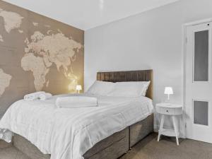 a bedroom with a large bed with a map on the wall at Lovely 2 Bed With Pool Table Ulverston - Pass the Keys in Ulverston