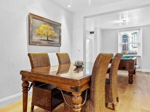a dining room with a wooden table and chairs at Lovely 2 Bed With Pool Table Ulverston - Pass the Keys in Ulverston +21 photos
