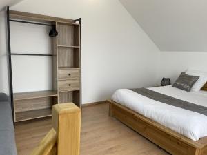 a bedroom with a bed and a book shelf at Gîtes Belle Vue in Saint-Léger-les-Mélèzes +44 photos