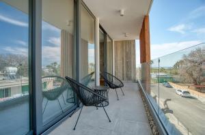 a balcony with two chairs and a table on it at Avenue 202 1 BED in Paphos