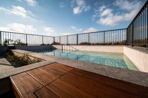 a swimming pool on a building with a fence at Avenue 202 1 BED in Paphos