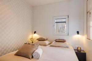 a bedroom with a bed with two pillows at Holland Houseboat Lemmer in Lemmer