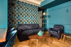 a living room with a leather couch and a table at JOIVY Elegant apartment Zaffiro near Porta Venezia in Milan +14 photos
