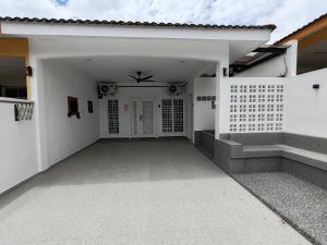 a white house with a white door and stairs at Loveu homestay 126 S2 in Seremban
